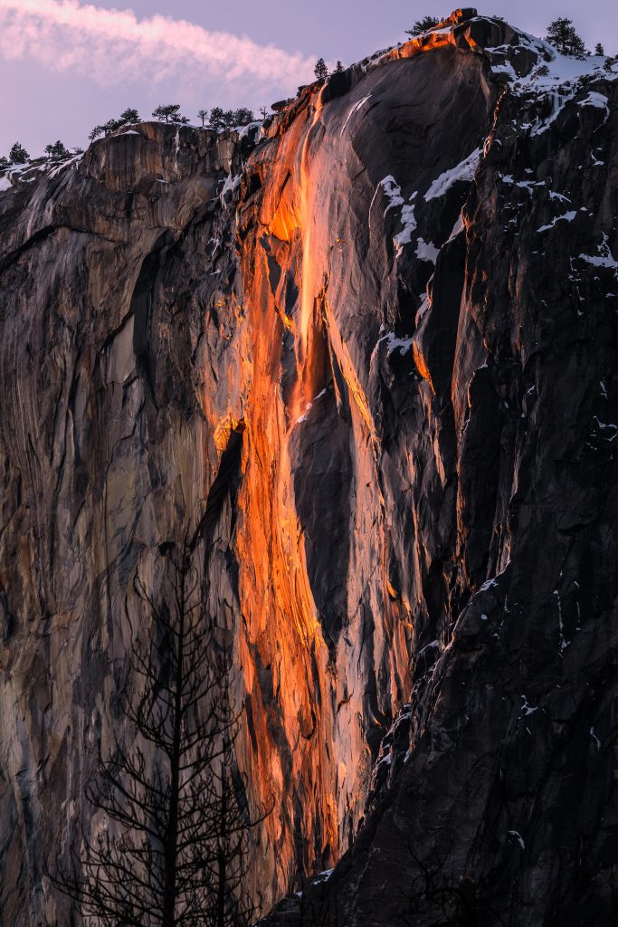 Yosemite Firefall glowing orange against a snowy cliff, photographed by Sheng Li